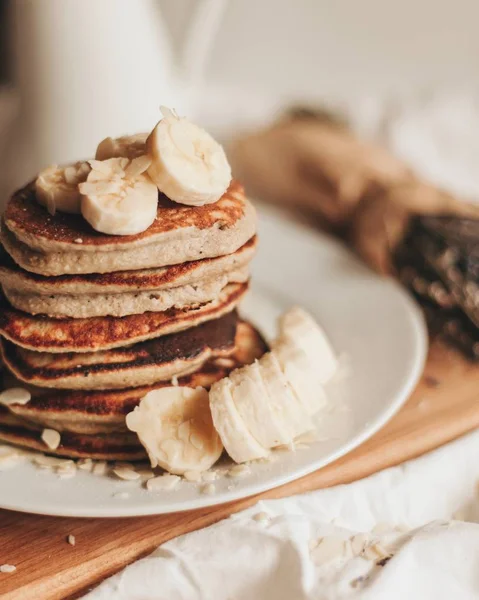 A stack of pancakes with bananas