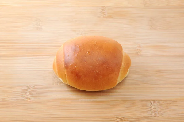 Rolo de pão de manteiga na placa de corte — Fotografia de Stock