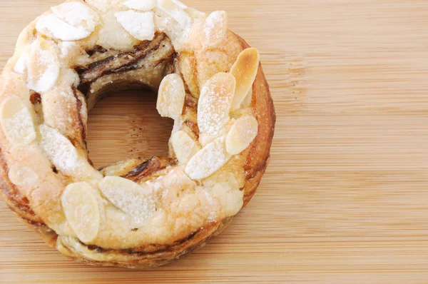 Sweet almond cake doughnut on table cutting board — Stock Photo, Image