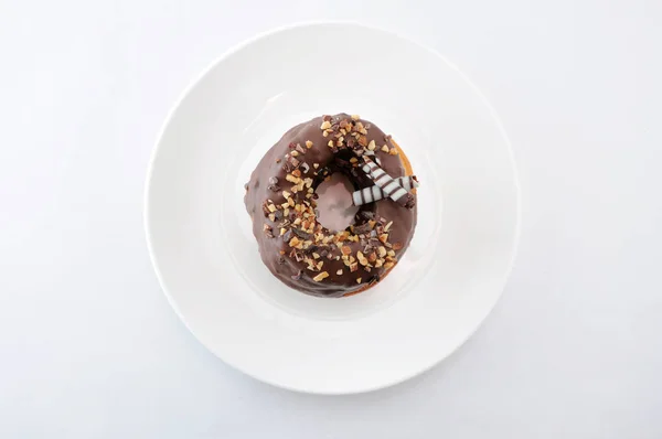 Sweet chocolate almond cake doughnut on a plate white background — Stock Photo, Image