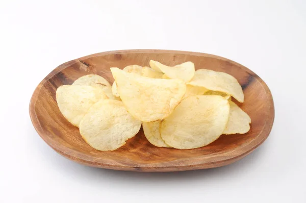 Potato chips on wood plate on white background Royalty Free Stock Images