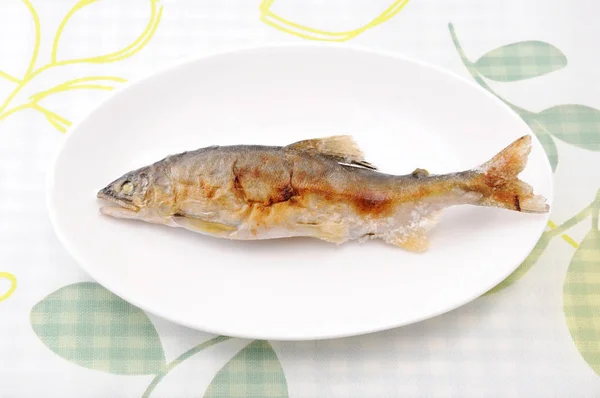 Grilled fish sweetfish with salt Japanese dish ayu no shioyaki on plate on table — Stock Photo, Image