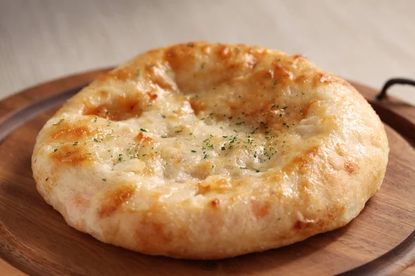 focaccia pizza bread isolated on a wood plate on table