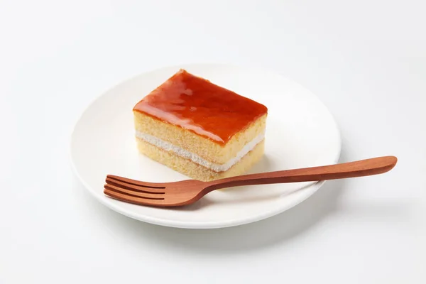 Orangen Honig Sirup Kuchen auf Teller mit Gabel isoliert auf weißem Hintergrund — Stockfoto