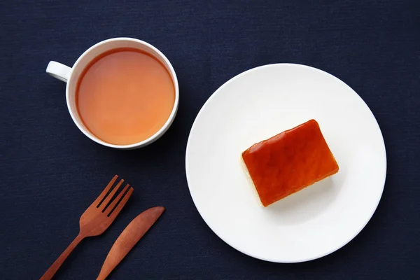 Tarta de miel de naranja en el plato con té caliente aislado en la mesa — Foto de Stock