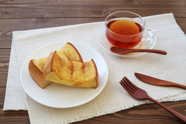 French toast and cup of tea isolated on table — Stock Photo, Image