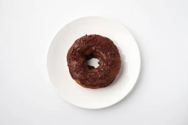 Chocolate frosted doughnut on plate isolated on white background — Stock Photo, Image