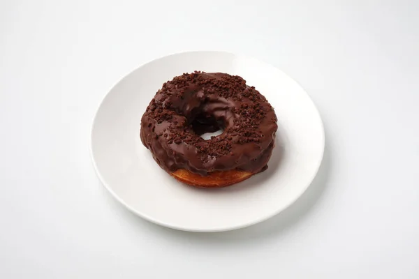 Chocolate frosted doughnut on plate isolated on white background — Stock Photo, Image