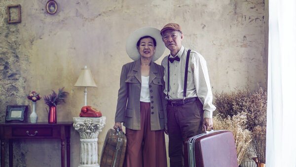 Vintage retro fashion Asian senior couple travel luxury trip after retirement