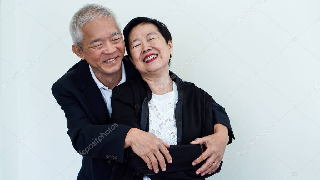 Happy smile Asian elderly couple in business attire, SME family owner