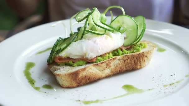 Eating Pesto Smoked Salmon Avocado Paste Poached Egg — Stock Video