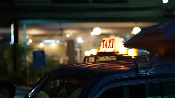 Taxi sign illuminate at night wait for passenger disrupted trans — Stock Photo, Image