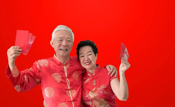 Asiatisches Seniorenpaar feiert chinesisches Neujahr in roter Tradition — Stockfoto