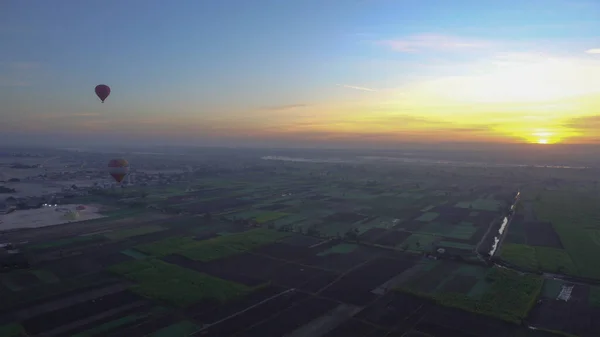 Aerial video motion riding hot air balloon over Luxor Egypt valley of the king Unesco heritage site sunrise