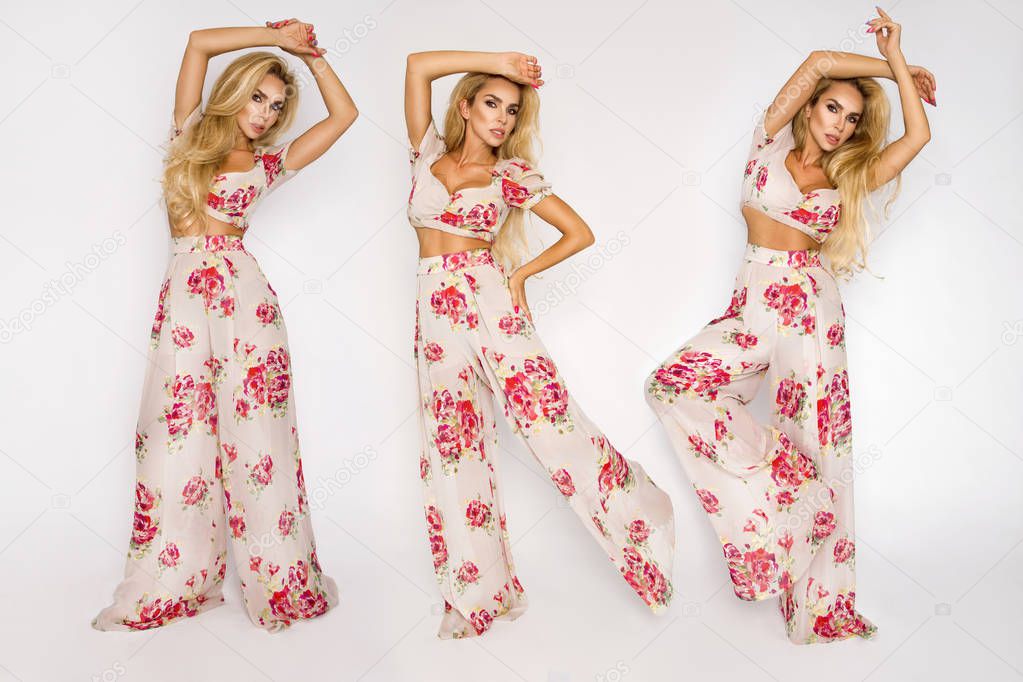 Beautiful, sexy, elegant woman with blonde hair poses in the studio in elegant clothes with flowers and a hat.