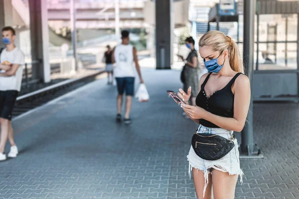 Woman in city street wearing face mask protective for spreading of Coronavirus