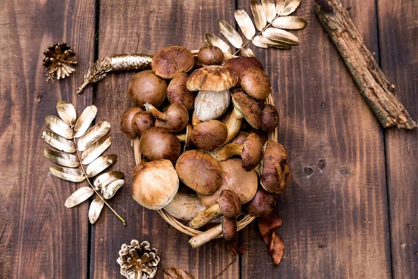 Orman hasırlı sepetten mantar topluyor. Üst görünüm fotokopi alanı. Masada taze çiğ mantar var. Tahta masadaki mantarlar..