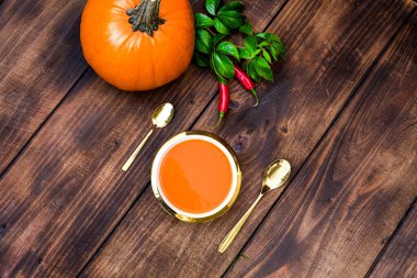 Beyaz ahşap zemin üzerinde kavrulmuş balkabağı ve kremalı havuç çorbası ve kabak çekirdeği. Uzayı kopyala Düz yatıyordu. Yemek pornosu.