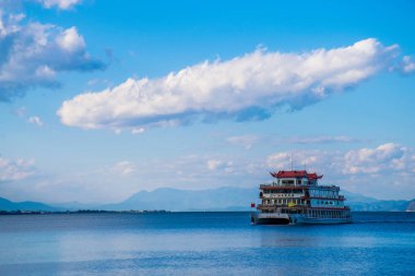 Dali, China - Oct 2018: The passanger farryboat on the mirror of Erhai lake in Yunnan province. Translation is 