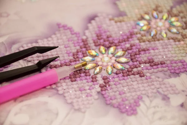 Diamond painting embroidery craft tools. Acrylic rhinestones. Closeup, selective focus