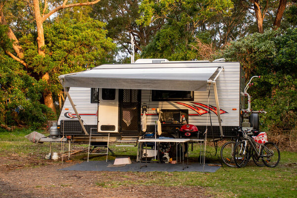 Camping site and the old style caravan set up with the awning