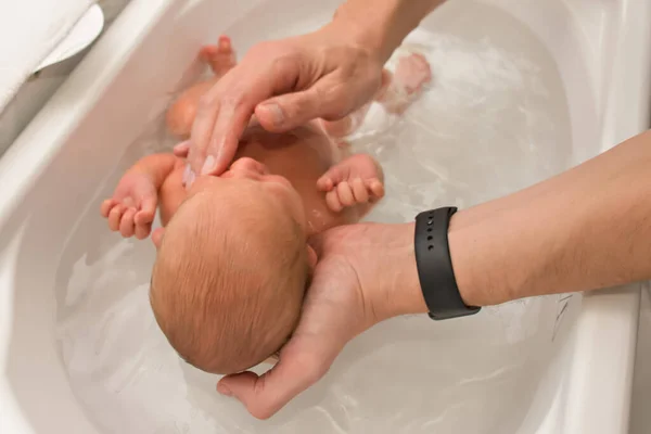 Father Hands Holding Bathing Newborn Baby White Baby Bath First — Stock Photo, Image