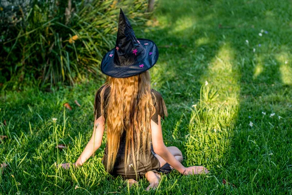 Causcasian Blond Girl Long Hair Halloween Witch Costume Sitting Green — Stock Photo, Image