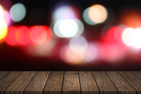 Empty Wooden table top with abstract night blurred bokeh city street lights background. — Stock Photo, Image