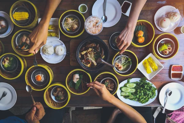 Top view of family enjoy eating Dim Sum breakfast food together.