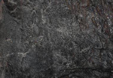 Koyu gri kayrak taşı dokusu arkaplanı.