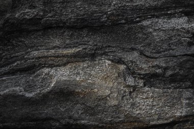 Koyu gri kayrak taşı dokusu arkaplanı.