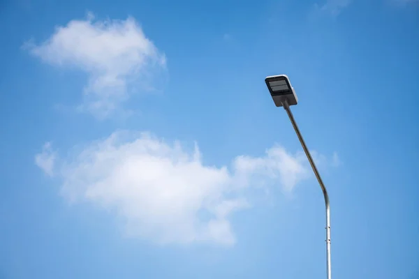 Street light LED on steel pole with blue sky and cloud.