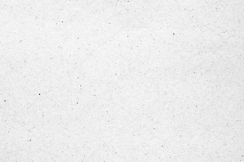 White paper or cardboard texture with black spot background.