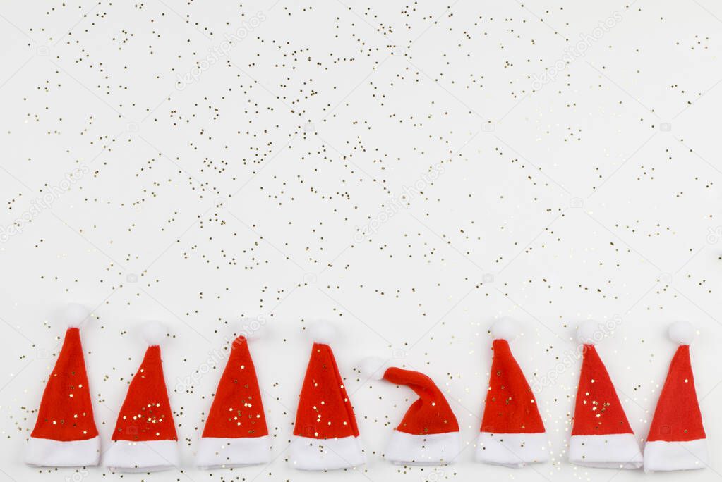 Santa Claus hats on white background with little stars. Christmas and New Year celebration. Christmas concept. Dissimilarity concept