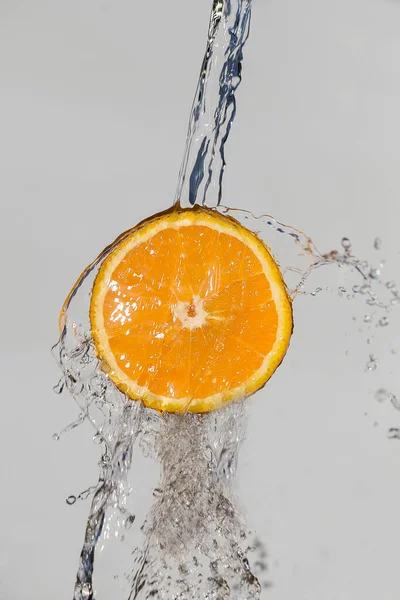 Orange in water splash on white background. summer concept