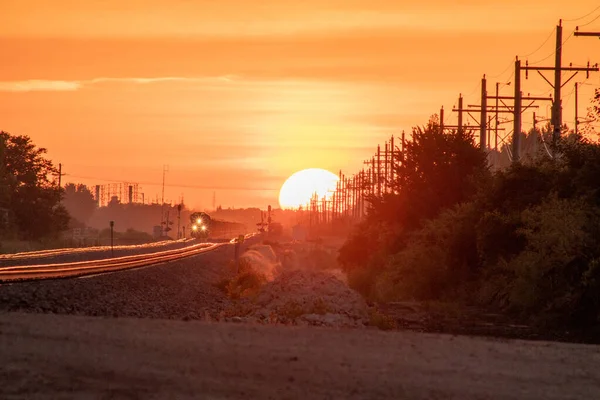 Passage à niveau et voies ferrées au coucher du soleil — Photo
