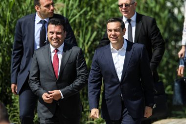 Prespes - Greece, June 17, 2018 : Greek Prime Minister Alexis Tsipras and his Macedonian counterpart Zoran Zaev walking before a signing agreement for Macedonia's new name in the village of Psarades clipart
