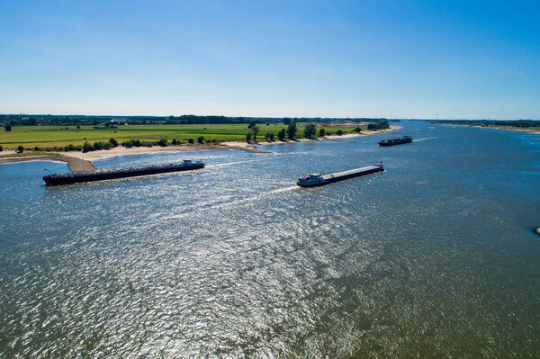 aerial view commercial ship crossing the River Rhine in an area of the Netherland
