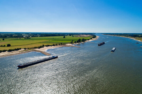 aerial view commercial ship crossing the River Rhine in an area of the Netherland