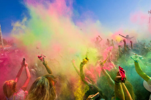 Thessaloniki, Greece - September 2, 2018: Crowds of unidentified people throw colour powder during the "Day of Colours" annual event.