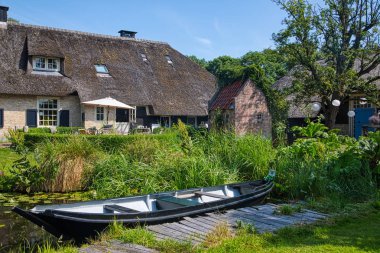 Giethoorn, Netherlands - July 4, 2018: view of famous village Giethoorn with canals in the Netherlands. Giethoorn is also called 'Venice of The Netherlands' 