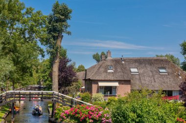 Giethoorn, Netherlands - July 4, 2018: view of famous village Giethoorn with canals in the Netherlands. Giethoorn is also called 'Venice of The Netherlands' 