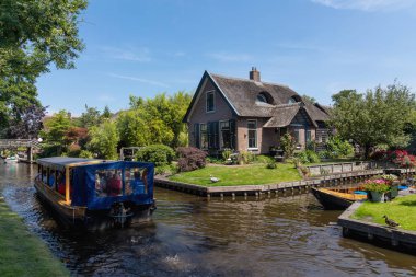 Giethoorn, Netherlands - July 4, 2018: view of famous village Giethoorn with canals in the Netherlands. Giethoorn is also called 'Venice of The Netherlands' 