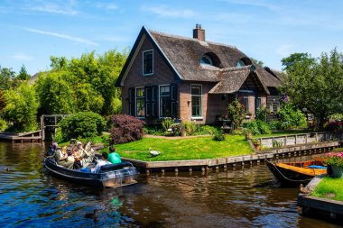 Giethoorn, Netherlands - July 4, 2018: view of famous village Giethoorn with canals in the Netherlands. Giethoorn is also called 'Venice of The Netherlands' 