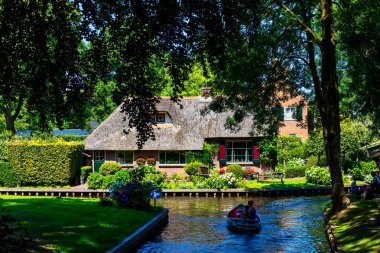 Giethoorn, Netherlands - July 4, 2018: view of famous village Giethoorn with canals in the Netherlands. Giethoorn is also called 'Venice of The Netherlands' 