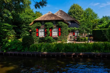 Giethoorn, Netherlands - July 4, 2018: view of famous village Giethoorn with canals in the Netherlands. Giethoorn is also called 'Venice of The Netherlands' 
