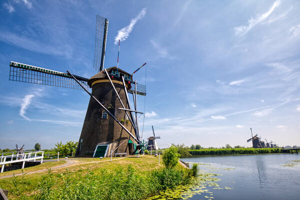 view of traditional windmills in Kinderdijk, The Netherlands. This system of 19 windmills was built around 1740 and is a UNESCO heritage site.