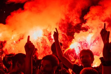 Thessaloniki, Yunanistan - 22 Eylül 2018: Müzik hayranları Selanik şehir açık tiyatro vahşi rock konserinde üzerinde yangın meşale yanmak. Kalabalık Festivali. Tehlikeli yanıcı havai fişek