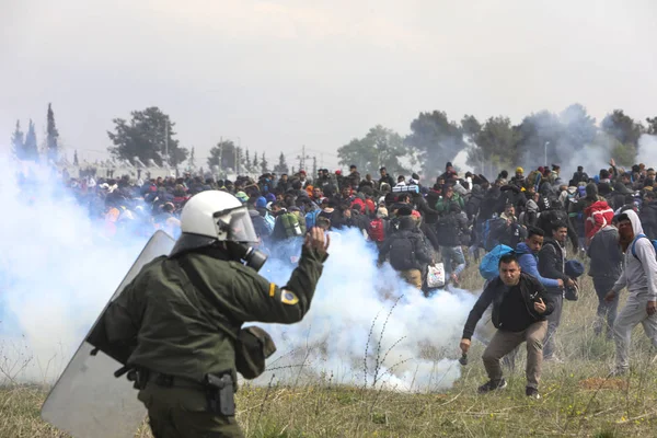 Migrantes entram em confronto com a polícia de choque grega fora de uma câmara de refugiados — Fotografia de Stock