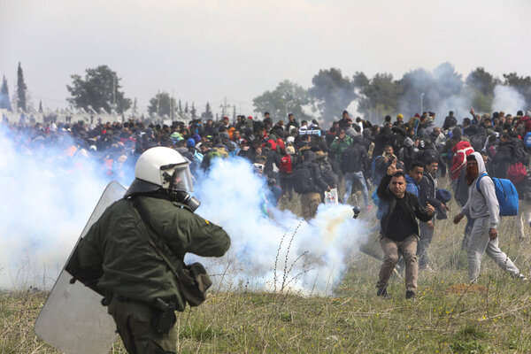 Migrants clashes with Greek riot police outside of a refugee cam